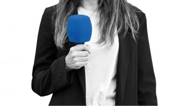 Female journalist holding a microphone