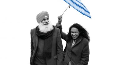 man and woman sharing umbrella