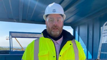 Picture of Kevin Garlick, GTIMC Manager, wearing a high vis jacket and hard hat