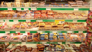 A selection of processed meats on a supermarket shelf