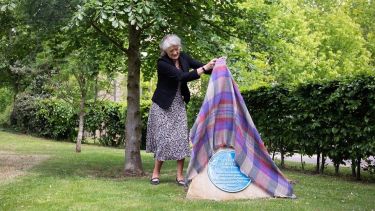 A photo showing  Dame Fiona Reynolds CBE unveiling the blue heritage plaque