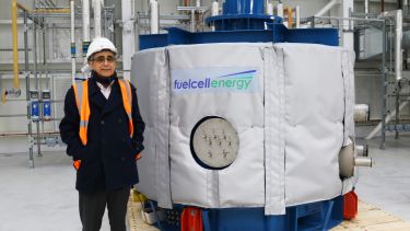 mohamed pourkashanian stands next to the new fuel cell which is a sat on a pallet at terc