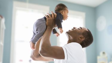 Father holding and interacting with baby