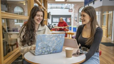 Two students studying in social space in Bartolome House