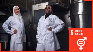 Two women in lab coats with sdg5 logo overlaid