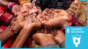 Group of hands with clean water splashing with sdg6 logo overlaid
