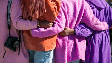 A group of people linking arms