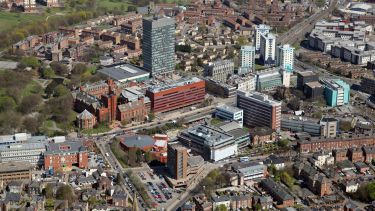 aerial view showing some university buildings either side of A57
