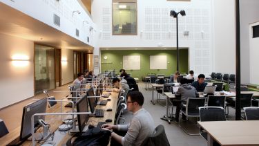 Students working in a shared study space on campus.