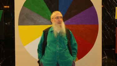 Image of Bob Brighton stood in front of a large colour wheel