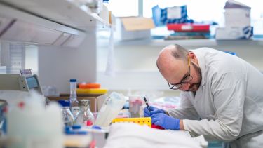 Scientist taking notes in SITraN