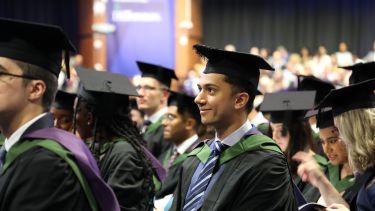 Image of graduate in hall smiling