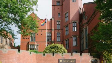 The Pride flag hanging outside Firth Court.