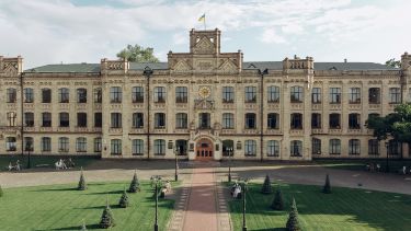 A grand building at the KPI campus in Kyiv, before the war with beautiful green gardens and trees