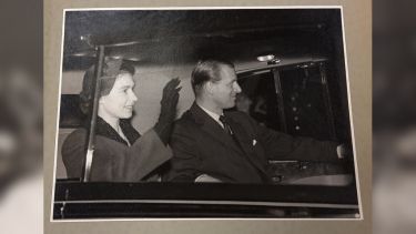 Her Majesty the Queen and HRH Duke of Edinburgh arriving in a car.