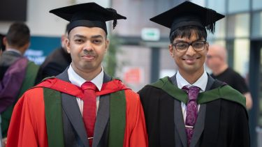 Nabhan and Mahdi stood together wearing graduation gowns