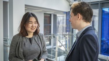 Two students chatting on the landing.