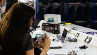 A student examines the electrical workings of an iron