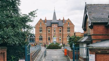 Exterior shot of red brick building from across the road