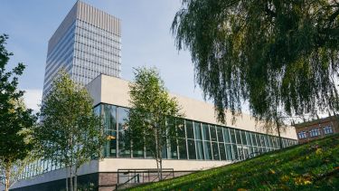 Exterior shot of western bank library and the arts tower from within weston park