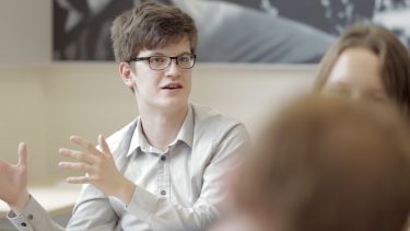 A Caucasian man talks in a seminar