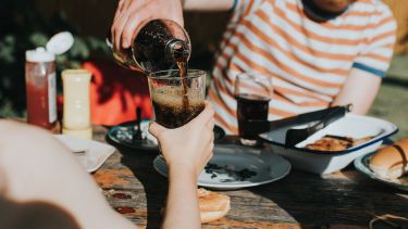 Person pouring coca cola
