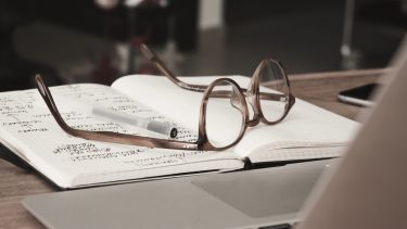 Image of reading glasses on a notebook