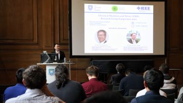 Photograph of Dr Xiao Chen opening the EMD Symposium event