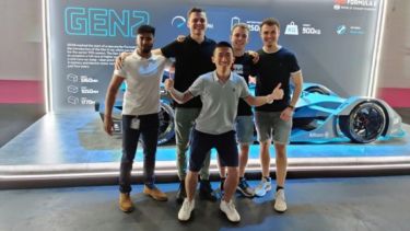 A photograph taken of Kacper with other ZF placement students on a trip to the London Formula E-Prix, standing in front of the Generation 2 electric car which is currently competing in the races