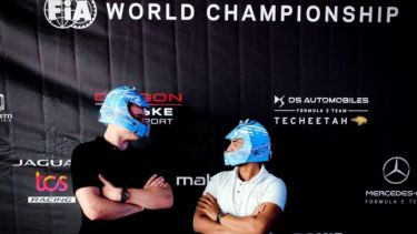 Kacper poses with a friend wearing race helmets at the London Formula E-Prix