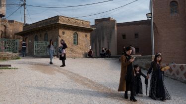 Women walking down a street in Erbil, Iraq