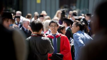 Image of a research student outside in a crowd