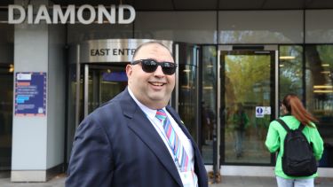 Dr Mahmoud Masoud standing outside the Diamond building on the day of the fair