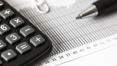Image of a calculator and pen