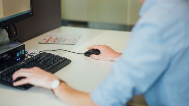 Student typing on a computer