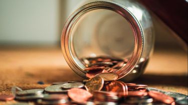 a jar of pennies spilled onto the ground.