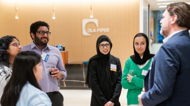 Alumni and students chat at a networking event