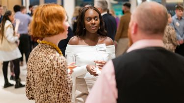 Students and alumni chat at a networking event