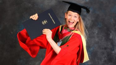 Bryony Page hon grad jumping in the air