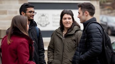 A group of students outside the Management School.