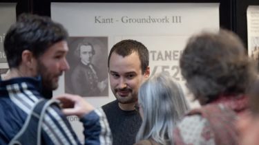 A group discussing a historical exhibit at a festival