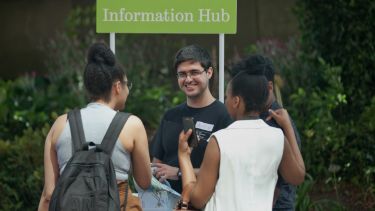 Student ambassador talking to guest at an open day