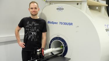 Richard Hodgkinson standing in front of a scanner