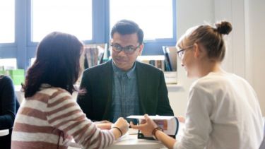 Three People Talking at a table
