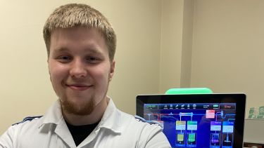 Critical care nurse stood in front of machines