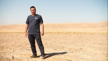 Dr Al Meselmani standing in the desert in Jordan