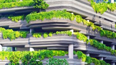 Garden parking lot - a car park featuring trees and shrubbery