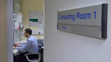 GP in consulting room