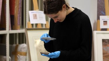 An image of a history student examining the Heritage Collections