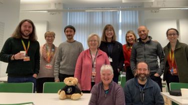 Group photo of staff in room 